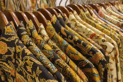 Full frame shot of clothes hanging on rack for sale in store