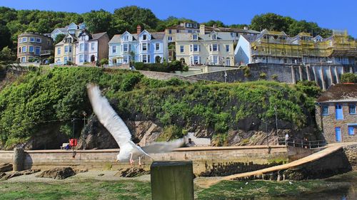 People in front of building against sky