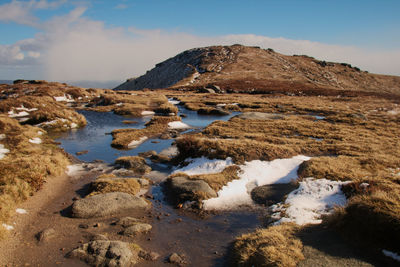 Scenic view of sea and mountains against sky