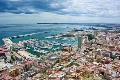 High angle view of buildings by sea against sky