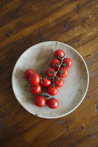 High angle view of cherries in plate on table