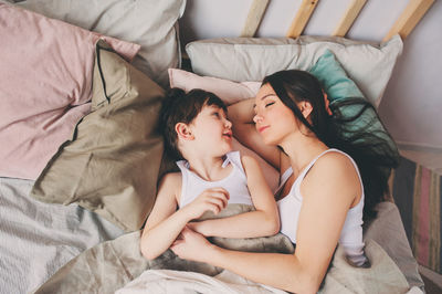 High angle view of woman relaxing on bed at home