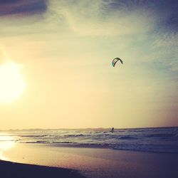 Scenic view of beach against sky during sunset