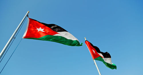 Low angle view of flag against sky