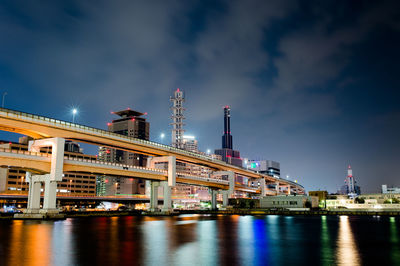 Low angle view of illuminated city against sky at night