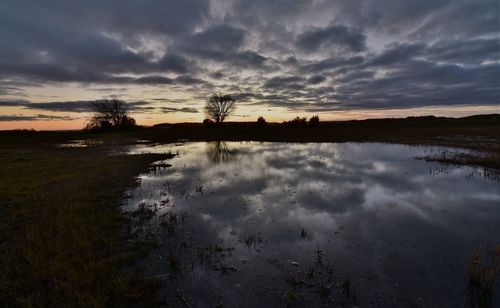 Scenic view of lake against sky during sunset