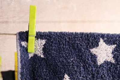 Close-up of blue towel drying on clothesline