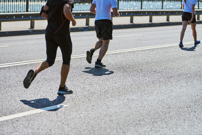 Running men. athletic men jogging in sportswear on city road. street marathon race, jogging outdoor