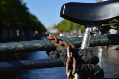 Close-up of metal chain against sky