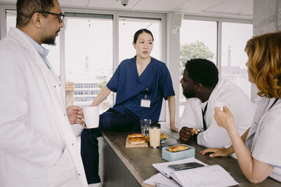 Medical colleagues discussing during lunch break at hospital