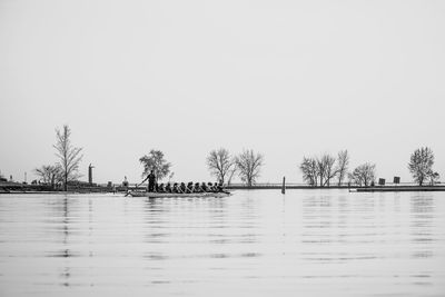 People in boat on lake against sky