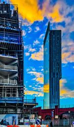 Skyscrapers against sky during sunset