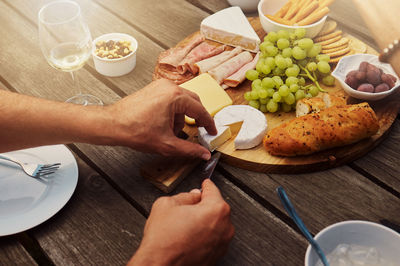 Cropped hands of person preparing food on table