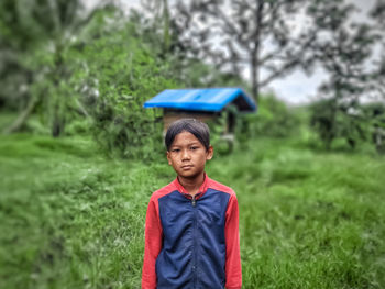 Rear view of woman standing in forest