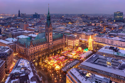 High angle view of illuminated buildings in city at night