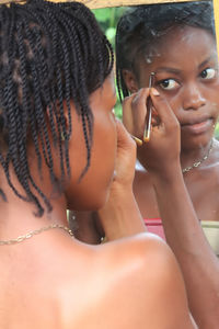 Rear view of young woman drinking water