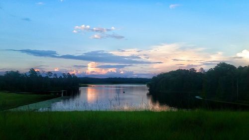 Scenic view of river against cloudy sky