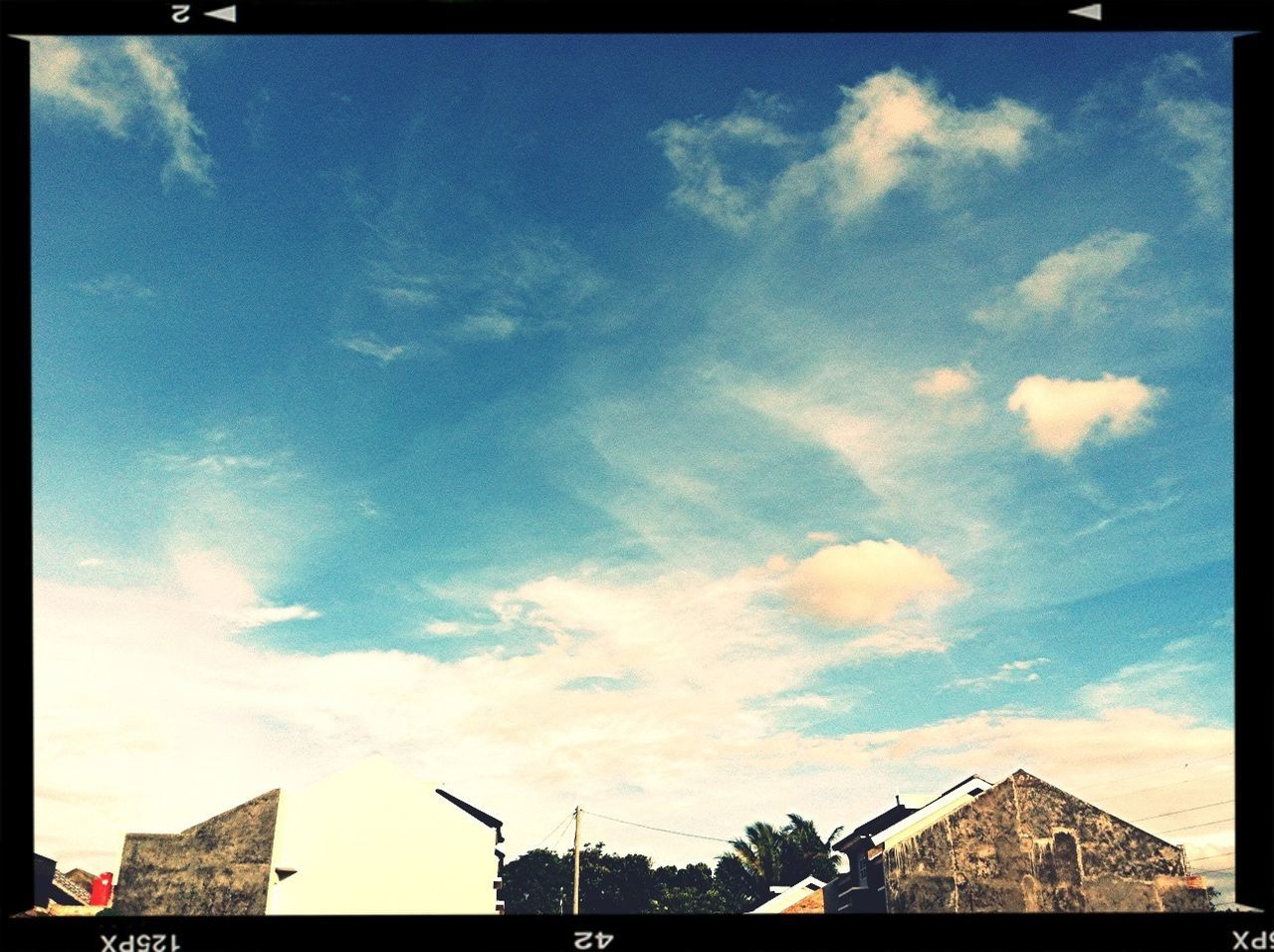 building exterior, sky, built structure, architecture, low angle view, transfer print, cloud - sky, auto post production filter, cloud, cloudy, house, high section, roof, outdoors, residential structure, no people, day, building, nature, residential building