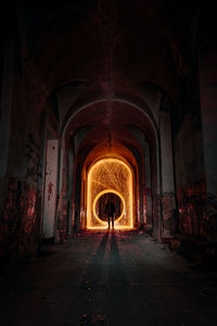 Rear view of man standing against wire wool