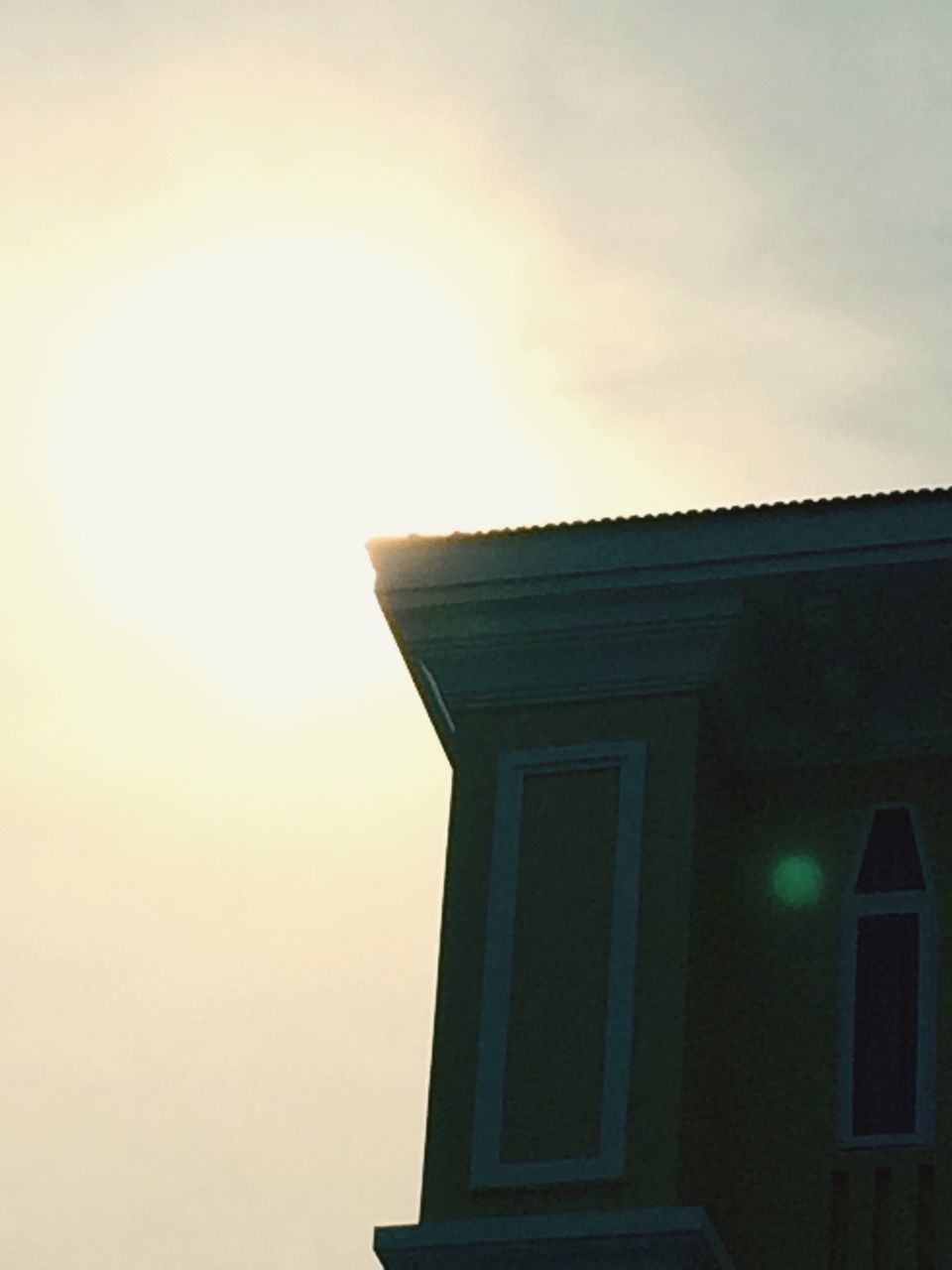 LOW ANGLE VIEW OF BUILDING AGAINST SKY AT SUNSET