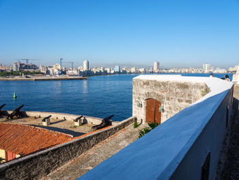 View of cityscape against clear blue sky