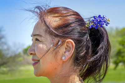 Close-up portrait of woman with red rose