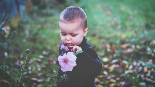 Close-up of boy with flowers