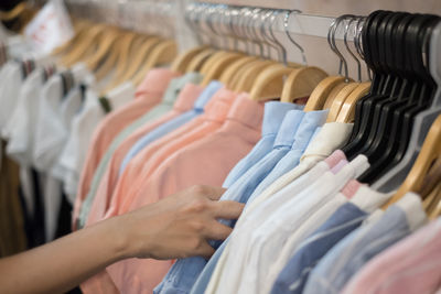 Cropped image of hand holding clothes 