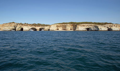 Bridge over river against clear blue sky