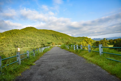 Empty road along countryside landscape