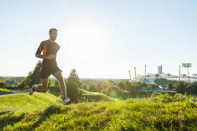 Man running on meadow in park