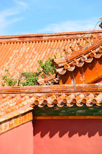 Low angle view of roof and building against sky