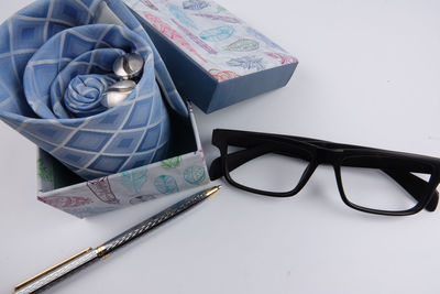 Close-up of eyeglasses and fabric of table