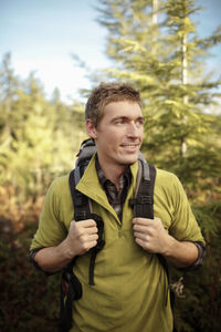 Portrait of young man standing in park