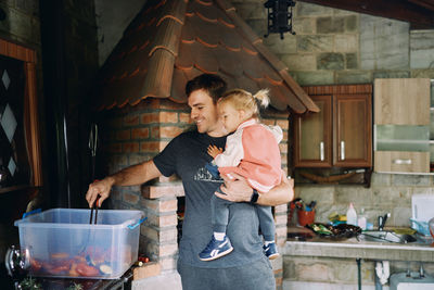 Side view of young woman standing at home