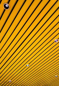 Low angle view of yellow striped ceiling with recessed lights
