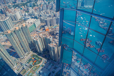 Reflection of victoria harbour on modern building in city