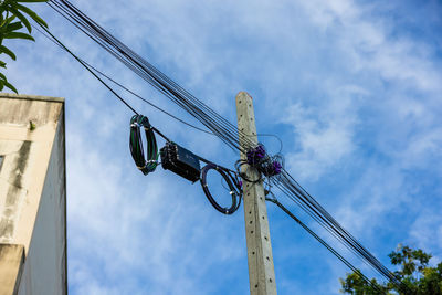 Low angle view of electricity pylon against sky