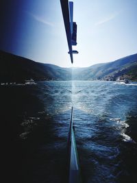 Sailboat in sea against clear sky