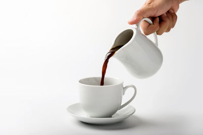 Close-up of coffee cup over white background