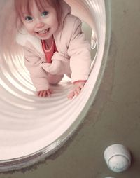 High angle view of young woman sitting on table