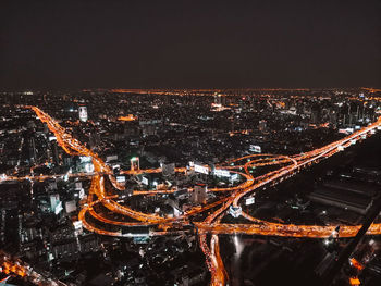 High angle view of illuminated city buildings at night