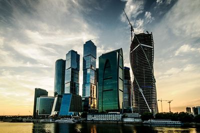 Buildings against sky at sunset