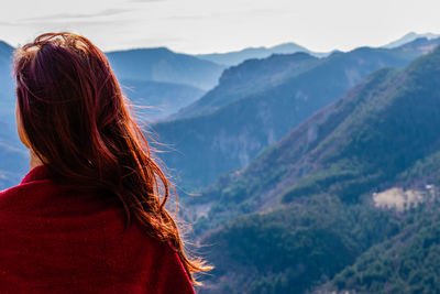 Rear view of woman looking at mountains