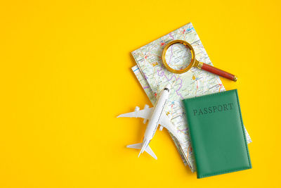 High angle view of clock on table against yellow background