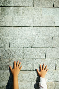 Low section of person against wall
