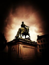 Low angle view of statue against cloudy sky