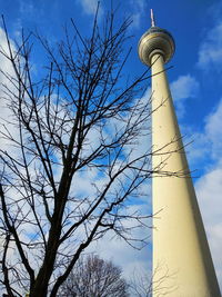 Low angle view of communications tower against sky