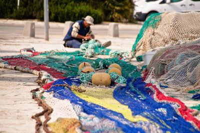 Fisherman with colorful fishing net at beach