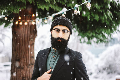 Portrait of man standing in snow